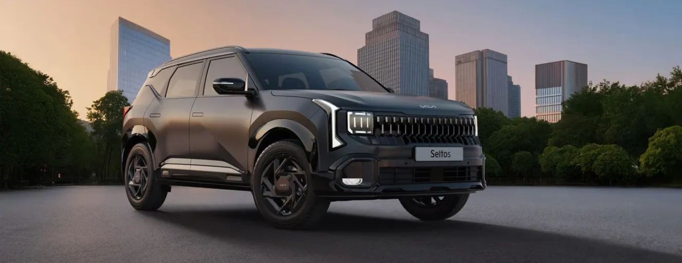 Front-three-quarter view of a black Kia Seltos parked in an urban setting with skyscrapers in the background at dusk.